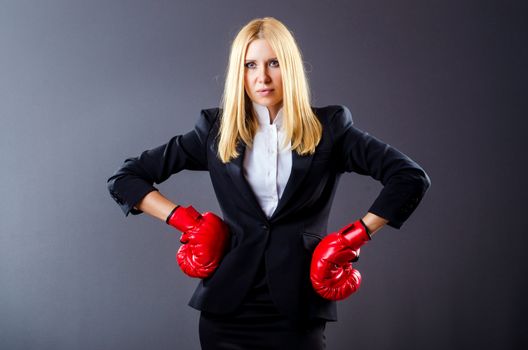 Woman boxer in dark room