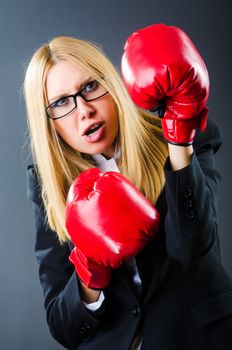 Woman boxer in dark room