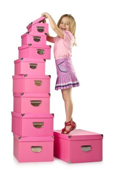 Little cute girl with lots of boxes