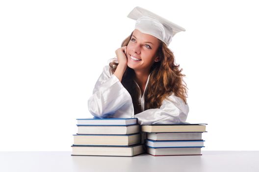 Happy graduate with lots of books on white