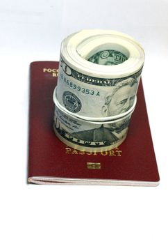Stack of paper usa dollars inside the red passport