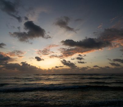 Beginning of Beautiful Ocean Sunrise over Water's Edge outdoors