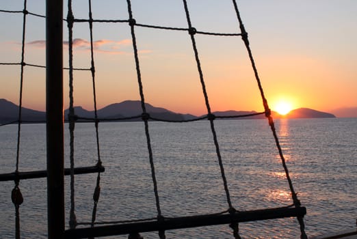 rigging of ship over sunrise