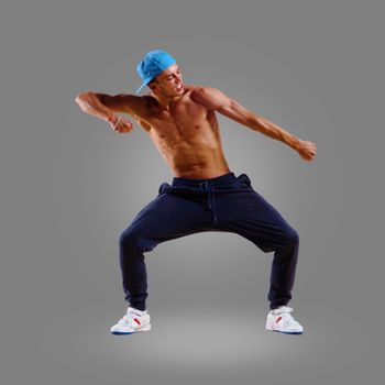 dancer of hip-hop on a gray background , motion