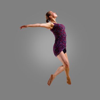 dancer jumping on a gray background, having a fun