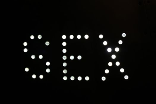 A sign made up of lightbulbs, reading sex