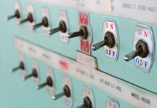 close up shot of toggle switch on off button panel on cargo vessel