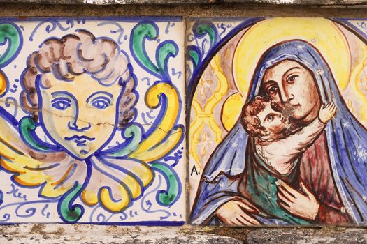 Close up of two antique tiles of angel and madonna, from Sicily, Italy