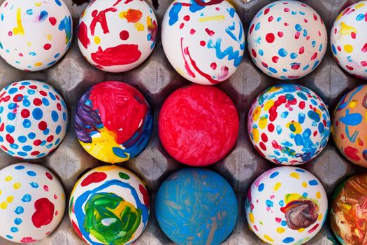 A tray of eggs painted by children for easter