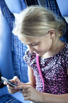 A pretty blonde girl reading message on her smart phone