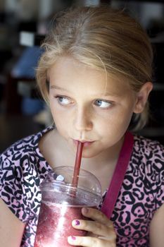 Child having a fresh shake, vertical portrait