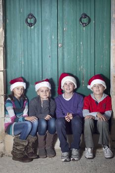 Children dressed in santa hats. Space for text