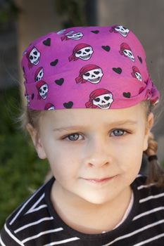 A cute little girl dressed up as a pirate. Soft focus on background
