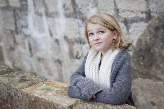 A beautiful child standing on a fortification