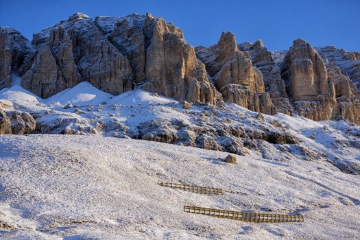 The Dolomites in the Veneto province of Northern Italy in late September. Seen from the mountain pass Pordoi 2245 m above sea an early morning after snowfall.
