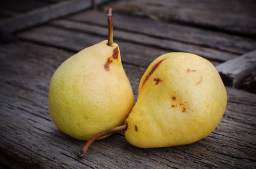 Homegrown pears on wooden background.