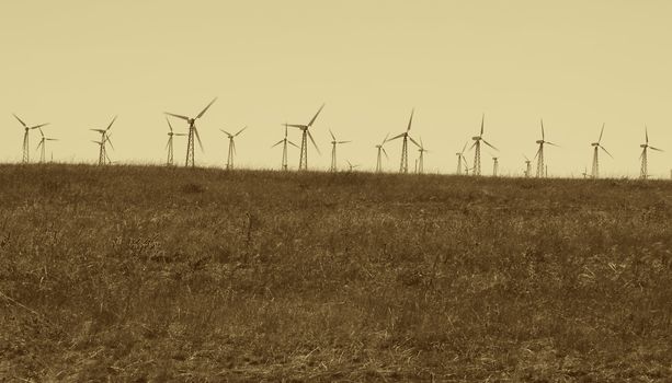 wind turbines at countryside in sepia