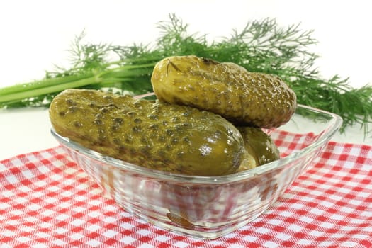 a glass bowl with fresh gherkins