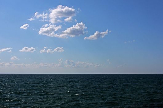 sea under blue sky with clouds