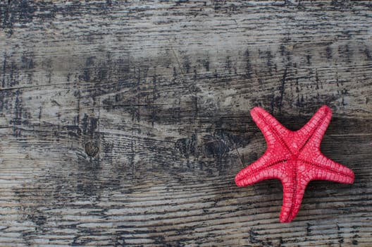 Starfish on a wooden background with a copyspace