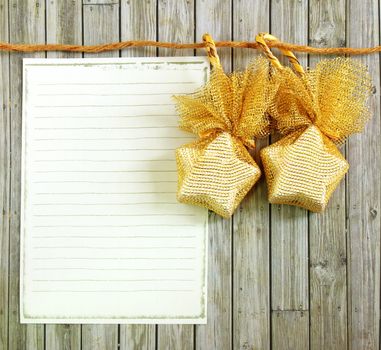 Christmas decoration with blank notebook over wooden background 