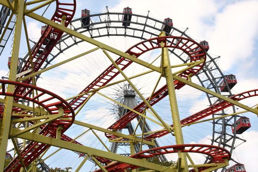Roller coaster and large ferris wheel in Prater, Vienna, Austria