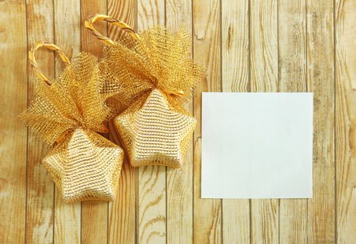 Christmas decoration with blank notebook over wooden background 