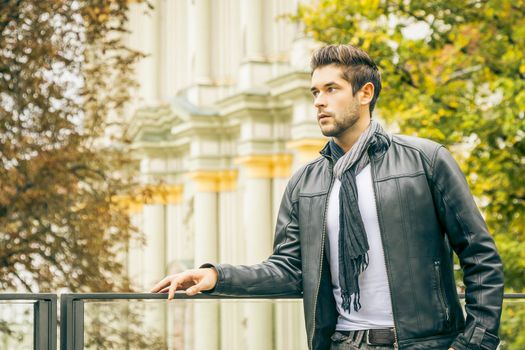 An image of a young man with a black leather jacket