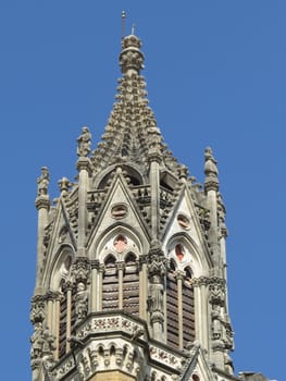 A detailed view of the top of a clock tower in India.                               