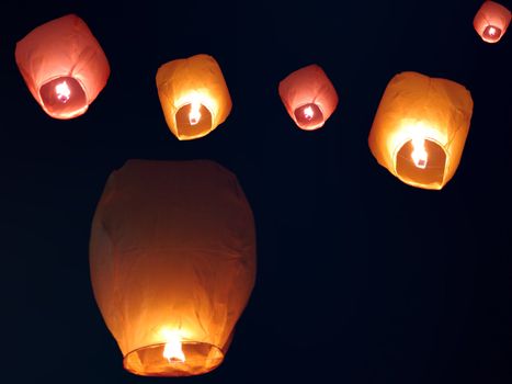Beautiful chinese sky lanterns floating in the sky on occassion of an Indian festival.                               