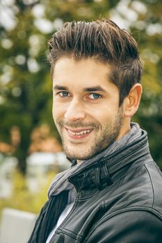 An image of a young man with a black leather jacket