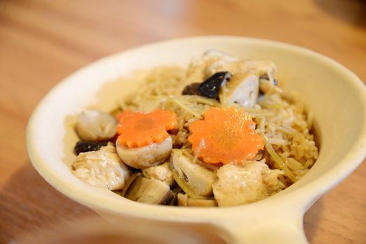 Plate of asian squid and rice in claypot