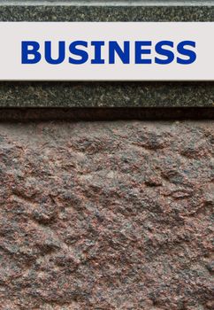 business sign on a granite wall (conceptual picture, tough business)