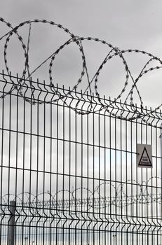 circular barbed wire and fence on a very overcast day