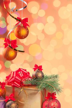Christmas festive background with gifts, balls on ribbon and green branch