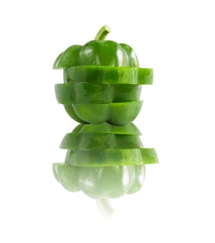 slice of green  bell pepper over  white background  with reflection