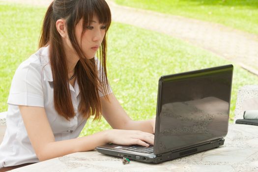 Asian young woman working with her notebook