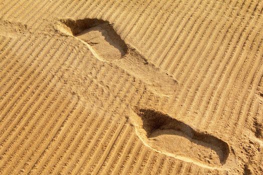 Human footprints on the fine beach sand
