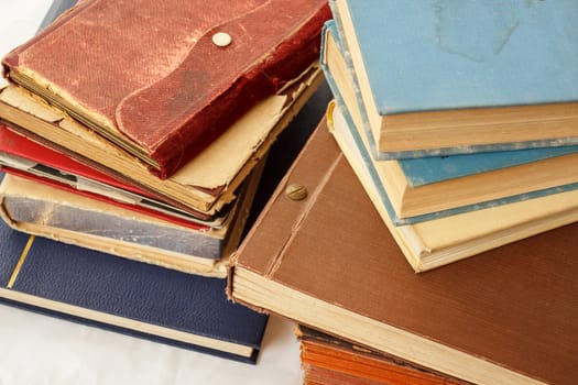 collection of old worn books on white