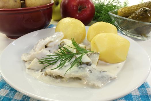 Cream herring with boiled potatoes and cucumber