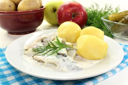 Cream herring with boiled potatoes and cucumber