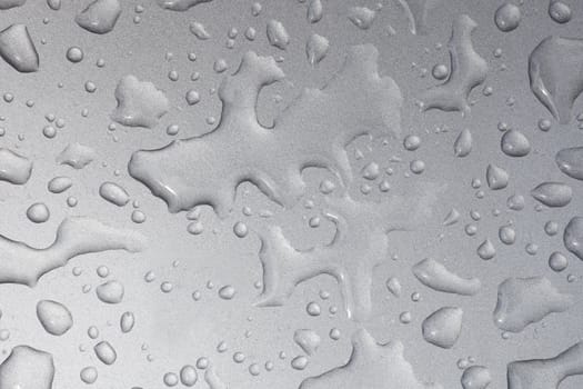 Close up image of water drops on metallic surface