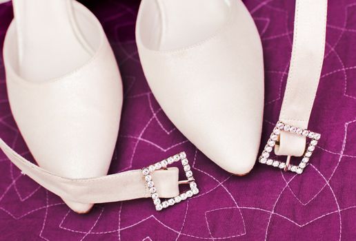 Detail of wedding shoes over purple color