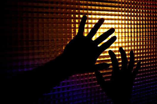 Abstract image of backlit silhouettes of hands