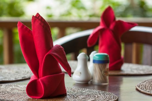 Folded napkins outdoors on a table in the tropics