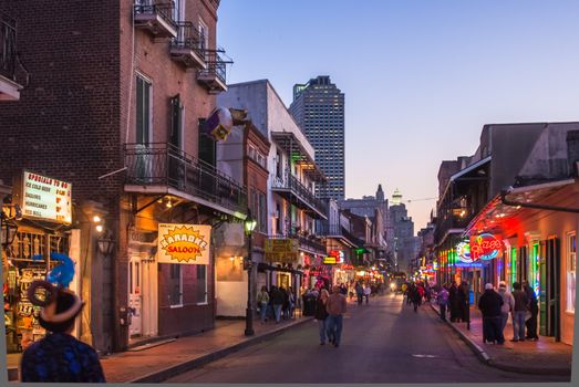 NEW ORLEANS, USA - CIRCA MARCH 2008: Crowds of people and neon lights at dusk circa March 2008 in New Orleans, USA. Tourism is the area's major source of income after Hurricane Katrina in 2005.