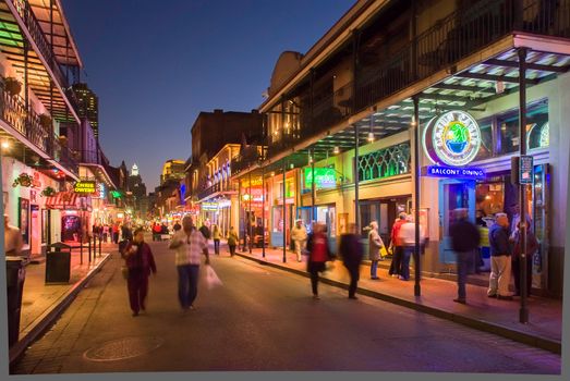 NEW ORLEANS, USA - CIRCA MARCH 2008: Crowds of people and neon lights at dusk circa March 2008 in New Orleans, USA. Tourism is the area's major source of income after Hurricane Katrina in 2005.