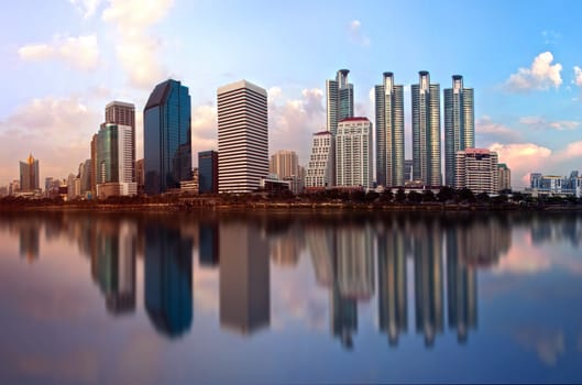 Beautiful city in the morning with a shiny building on the water.