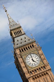 Britain national symbol Clock Big Ben (Elizabeth tower in Gothic Revival style) at 5 o’clock on cloudy sky background in London