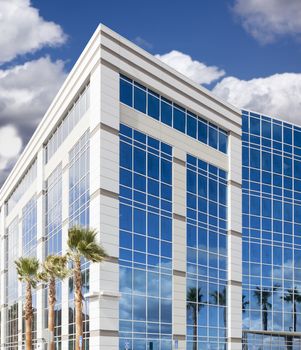 Dramatic Reflective Corporate Building with Blue Sky and Clouds.